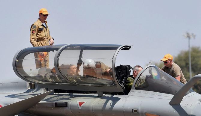 Reliance Group Chairman Anil Ambani sit inside the cockpit of Rafale aircraft before a sortie during the 2nd day of the 11th biennial edition of AERO INDIA 2017 at Yelahanka Air base in Bengaluru on Wednesday. Pic/PTI
