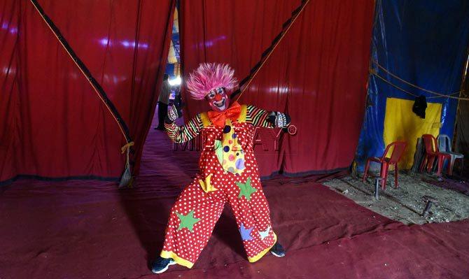 A clown strikes his best pose for the cameras, backstage at Rambo Circus