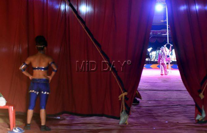 A gymnast waits for her turn on stage at Rambo Circus