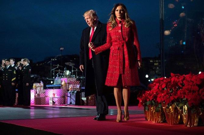Donald Trump and First Lady Melania Trump walk off the stage during the 95th annual National Christmas Tree Lighting ceremony