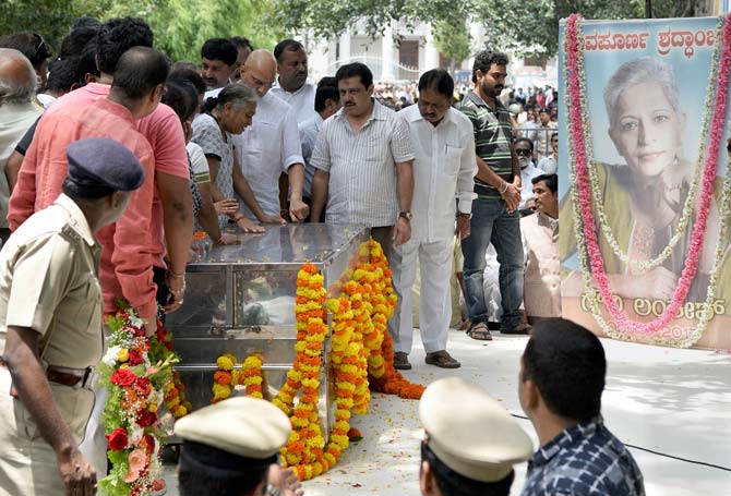 A police honour guard gave a gun-salute to the slain journalist.