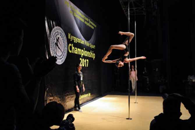 Participants perform a routine during the 'Kyrgyzstan Pole Sport Championship 2017' competition in Bishkek, on November 4, 2017. Contestants from Kyrgyzstan and Kazakhstan took part in the pole dancing championship.All images/AFP