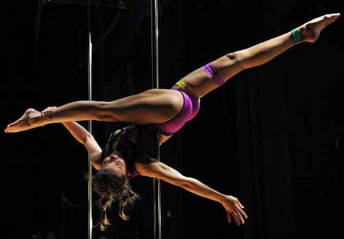 A participant performs a routine during the 'Kyrgyzstan Pole Sport Championship 2017' competition in Bishkek, on November 4, 2017. Contestants from Kyrgyzstan and Kazakhstan took part in the pole dancing championship