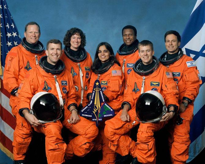 This October 2001 NASA photo shows the seven STS-107 crew members posing for the traditional crew portrait. Seated in front are astronauts Rick D. Husband (L), mission commander, Kalpana Chawla, (C) mission specialist, and William C. McCool, pilot. Standing are (From L) astronauts David M. Brown, Laurel B. Clark, and Michael P. Anderson, all mission specialists, and Ilan Ramon, payload specialist representing the Israeli Space Agency.