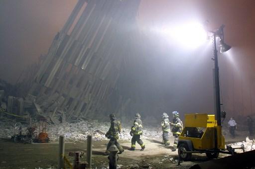 Firefighters make their way through the rubble of the World Trade Center on the fateful day of September 11, 2001, in New York after two hijacked planes flew into the landmark skyscrapers.