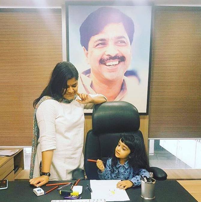 Following in her father's fine traditions, Poonam Mahajan is seen here familiarising her daughter, Avika, with her office and work