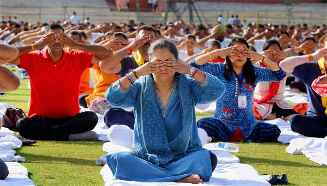 Rajasthan Chief Minister Vasundhara Raje took part in a yoga session during a Yoga event at the SMS stadium in Jaipur. In the photo, here she is doing brahmari pranayam
