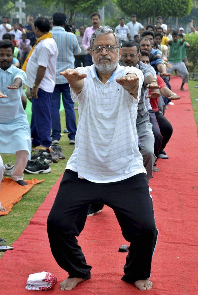 BJP senior Leader Shusheel Kumar Modi performs Yoga during an event at Shivaji Park in Patna