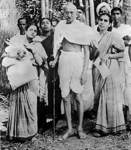 In picture: Mahatma Gandhi (C) poses with women during his tour of the Bengal province in 1946.