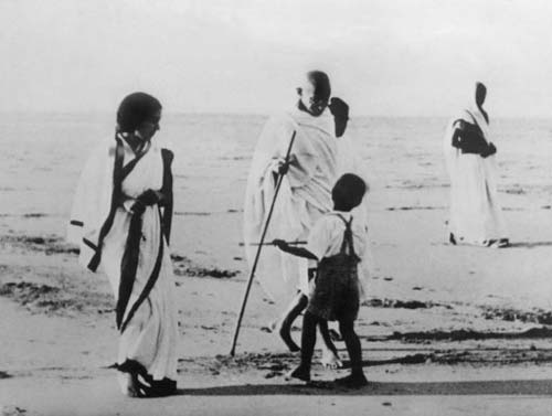 Picture dated January 12, 1938, of Mahatma Gandhi, accompanied by young followers, walking on a beach near Bombay (now Mumbai).