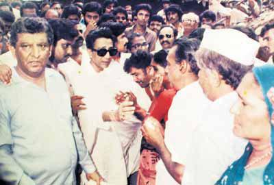 Bal Thackeray is flanked by people in this undated picture.
