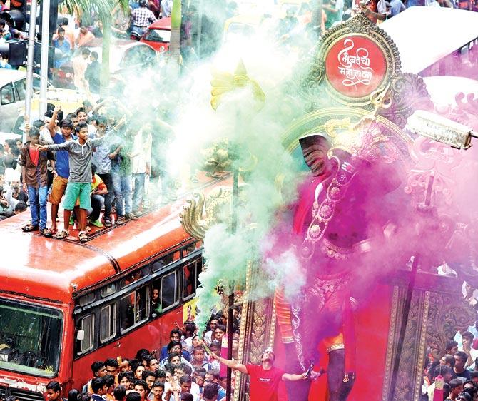 READY TO GO: It is a riot of colour as an idol is taken to a pandal. Pic/Rane Ashish READY TO GO: It is a riot of colour as an idol is taken to a pandal. Pic/Rane Ashish