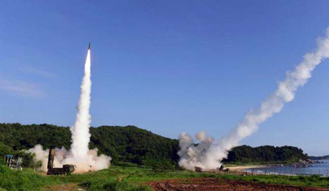 This handout photo taken on July 5, 2017 and provided by South Korean Defence Ministry in Seoul shows South Korea's Hyunmu-2 Missile System (L) and US M270 Multiple Launch Rocket System (R) firing missiles into the East Sea from an undisclosed location on South Korea's east coast during a South Korea-US joint missile drill aimed to counter North Korea's ICBM test.South Korea and the United States fired off missiles on July 5 simulating a precision strike against North Korea's leadership, in response to a landmark ICBM test described by Kim Jong-Un as a gift to 'American bastards'.