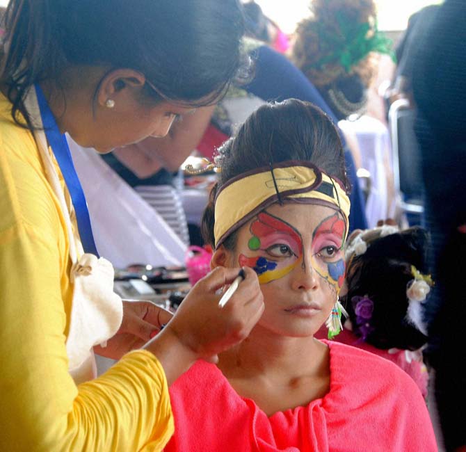  A makeup artist paints a model's face for a Hair and beauty contest organized by All India Beauty Association in Guwahati on Tuesday. Pic/PTI