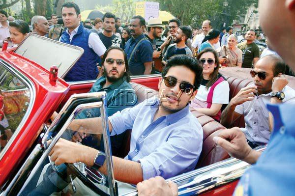 Mukesh Ambaniu00e2u0080u0099s sons Akash (r) and Anant took one of the cars for a spin as onlookers cheered them