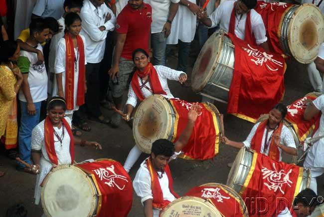 Dhol players from the Parleshwar Ganpati Mandir perform as revellers look on. Pic/Pradeep Dhivar. 