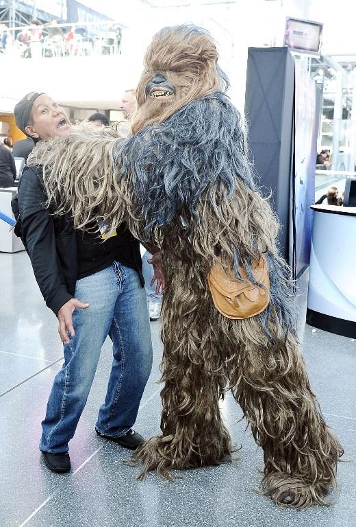 An attendee in a Chewbacca outfit from the Star Wars film franchise poses for the cameras