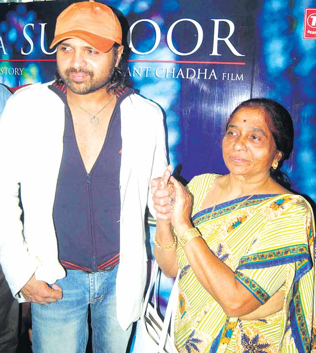Musician-cum-actor Himesh Reshammiya holds hands with his mother Madhoo at a film event.