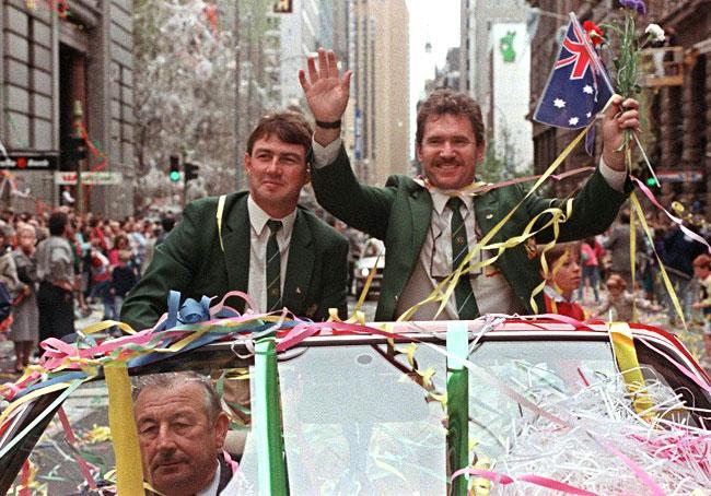 Fant'ash'tic! Allan Border (R), accompanied by Geoff Marsh, waves the national flag on September 28, 1989, during a parade to celebrate the winning of the Ashes, which Australia had regained for the first time on English soil since 1934