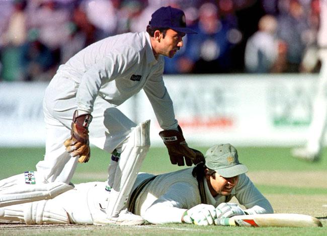 The 'fall' guy: This was a rather common sight in the 90s. Pakistan's Inzaman-Ul-Haq (R) loses his balance as India's Saba Karim tries to knock the bails off the stumps during an ODI in Canada in 1997