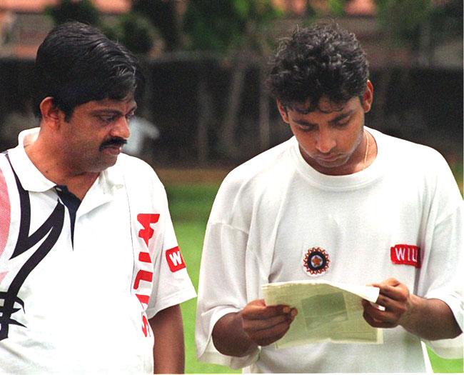 Beginning of the end: Ajay Jadeja reads a fax copy of a magazine article on July 22, 1997 in which he is implicated in a match-fixing scandal by former Pakistani wicket-keeper Rashid Latif. Then Indian team manager Ratnakar Shetty looks on