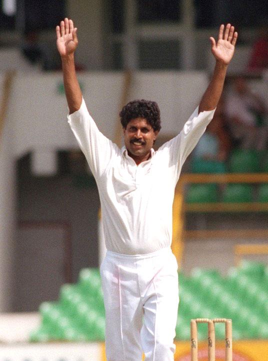 Aus-some achievement: Kapil Dev raises his arms after taking his 400th test wicket during the fifth test against Australia in Perth on February 3, 1992