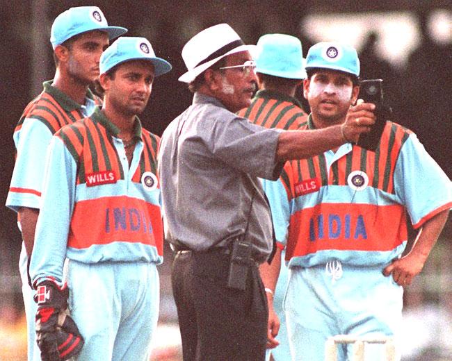 A different Men in Blue: That's how India's jersey looked in 1997. Sri Lankan umpire K. T. Francis (C) checks the light while Sachin Tendulkar, Nayan Mongia and Sourav Ganguly look on during an ODI in Colombo on August 23, 1997