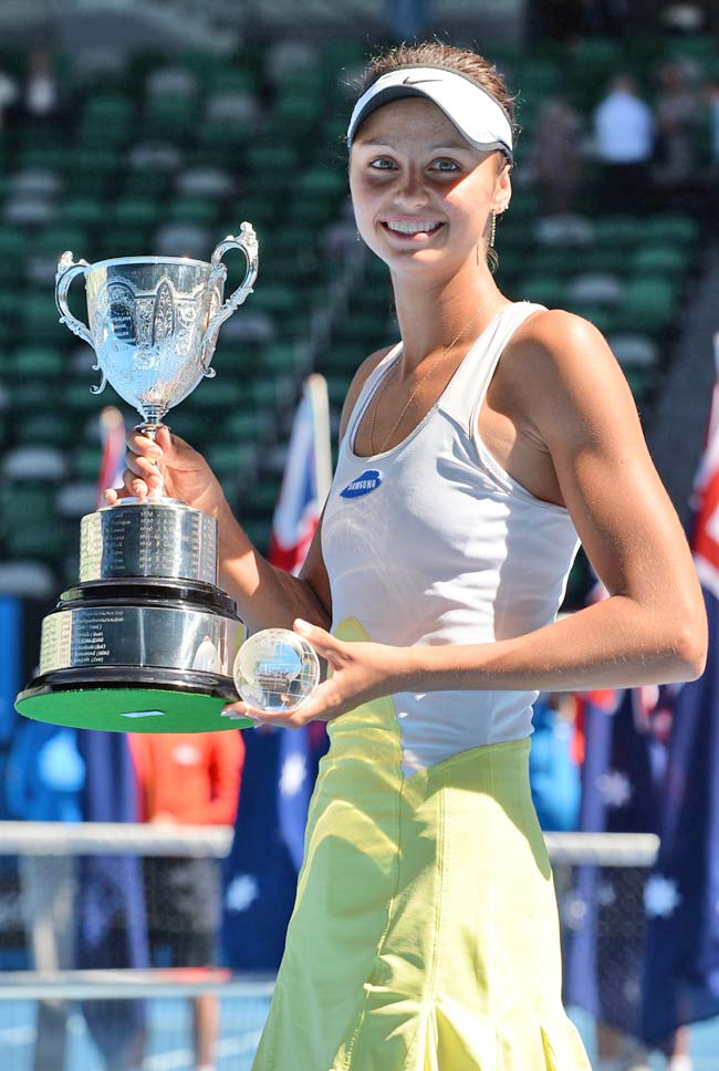 Elizaveta Kulichkova of Russia poses with the trophy as she celebrates after victory in her girls singles final match against Jana Fett of Croatia