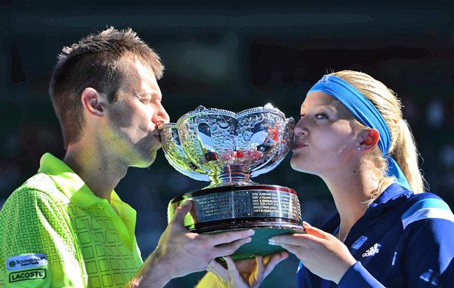 Kristina Mladenovic of France (R) and Daniel Nestor of Canada pose with the trophy as they celebrate victory in their mixed doubles match against Horia Tecau of Romania and India's Sania Mirza