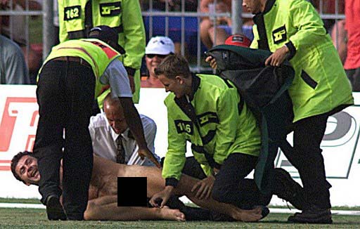 Down for the count: An English streaker is stopped by security people on December 12, 1999, during the match between England and South Africa in the Saint Georges Park in Port Elizabeth. Pic/ AFP