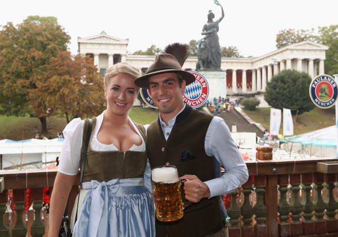 Bayern Munich's defender Philipp Lahm (R) and his wife Claudia pose during the traditional visit of FC Bayern Munich at the beer festival Oktoberfest in Munich, southern Germany.