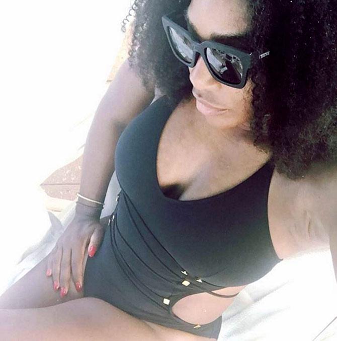 In pic: Serena Williams shows off her cleavage in a black swimsuit