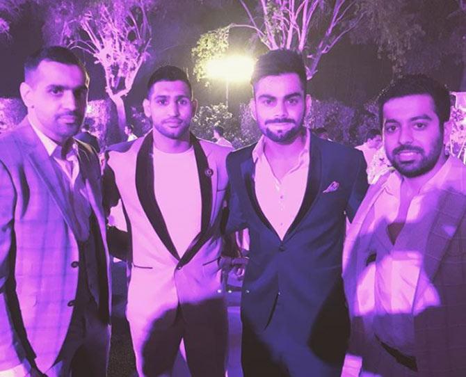 Now for some photos of Amir Khan with celebrities! Amir seen here with India captain Virat Kohli at an event.