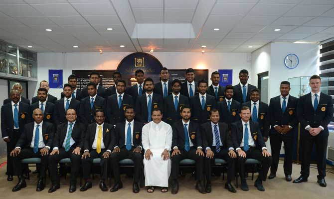 Sri Lankan Sports Minister Dayasiri (C) poses for a photograph with the country's cricket team as they prepare to leave for their forthcoming England tour in Colombo on Wednesday. Pic/AFP