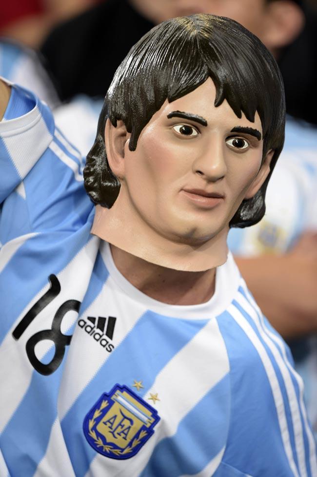 Argentina's fan wears a mask of Argentina's forward and captain Lionel Messi before the Group F football match between Argentina and Bosnia-Hercegovina