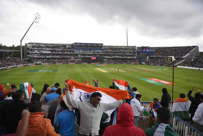 Indian cricket fans wave the national flag