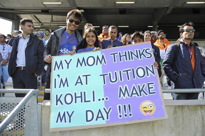 Young Indian cricket fans hold a placard in support of their team before the start of the ICC Champions Trophy match between India and Pakistan