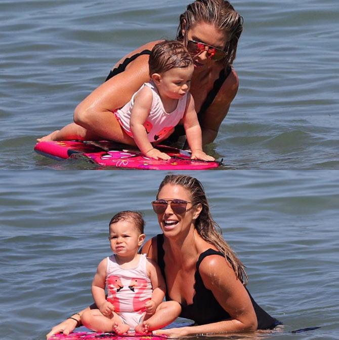 Candice Warner first competed in the Ironwoman series at the age of just 14. In pic: Candice with her daughters Ivy Mae and Indy Rae in February 2017: This week we took the girls to the beach and I introduced Indi to a board for the first time. She wasn't keen to take after mummy and become an Ironwoman, however she did enjoy relaxing and using the board as a seat. More lessons to come I think @davidwarner31. #love #waterbaby