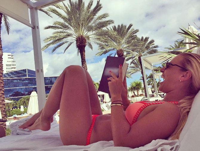 Dominika Cibulkova reads a book by the beach