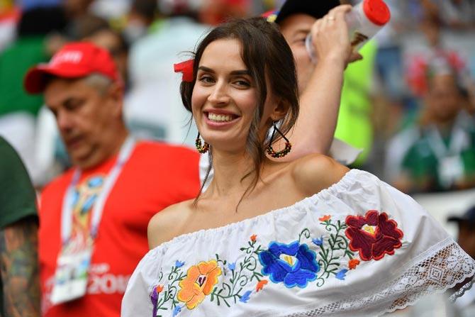 A football fan poses before the Russia 2018 World Cup round of 16 football match between Brazil and Mexico at the Samara Arena in Samara on July 2, 2018.