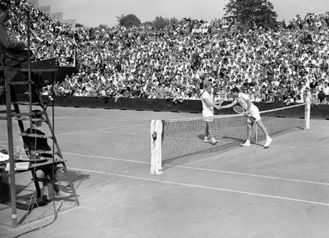 Italian tennis player Nicola Pietrangeli (right) shakes hands with his opponent Australian Lewis Hoad at the end of their quarter final match