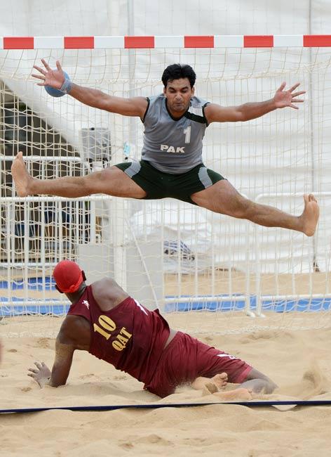 Tahir Ali of Pakistan fails to stop a goal by Ali Mohamed of Qatar during their men's beach handball match which Qatar won 2-0 at the 3rd Asian Beach Games in Haiyang, Shandong Province on June 19, 2012.