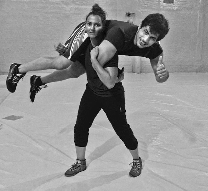Geeta Phogat proves she is as strong as any man! Here seen carrying her husband Pawan Kumar