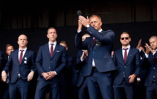 Iceland's manager Heimir Hallgrimsson (3rd R) acknowledges the crowd next to the Iceland national football team during the welcoming ceremony. Pic/AFP