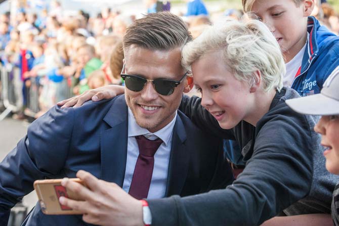Iceland's midfielder Arnor Ingvi Traustason poses for photograph as he arrives with his team in Reykjavik while people in the streets greet them as winners. Pic/AFP