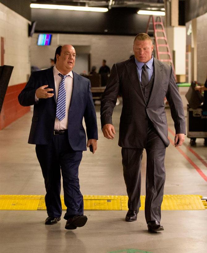 A rare photo of Brock Lesnar in a suit along with Paul Heyman (L) during WrestleMania 31