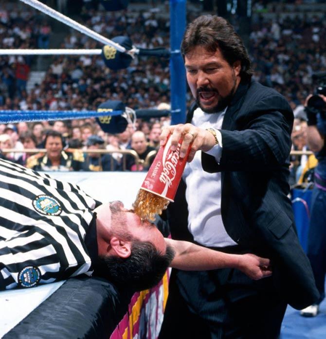 Million Dollar Man pours coke on a referee at WrestleMania 12