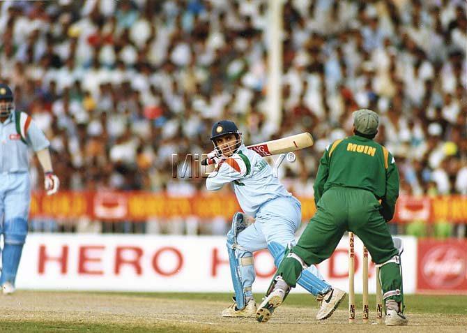 Sourav Ganguly plays a shot as Moin Khan looks on