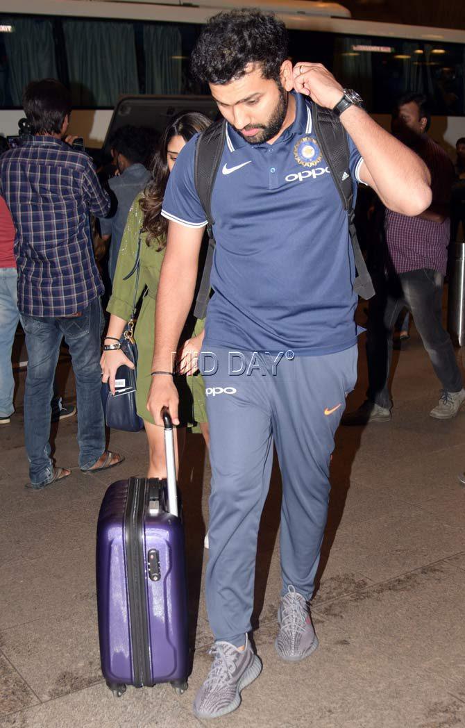 Batsman Rohit Sharma spotted at Mumbai airport enroute to South Africa. Rohit who ranked 14th in the ICC Twenty20 International (T20I) rankings, scored 162 runs during the recent series against Sri Lanka, which included a knock of 118 in the second match in Indore. Pic/Sameer Markande