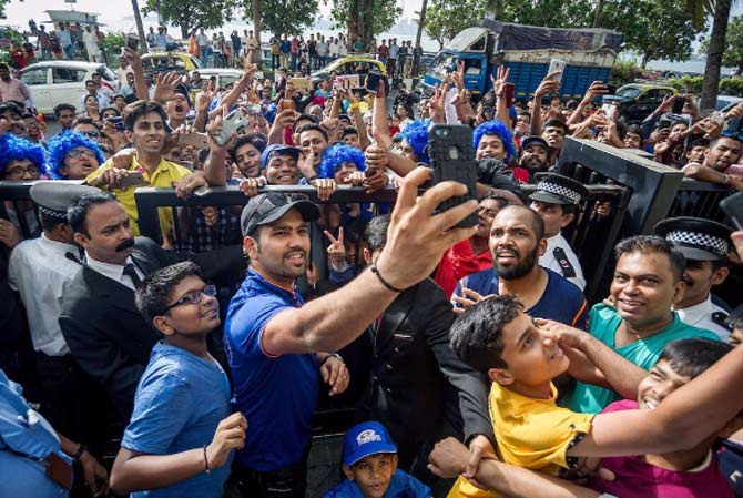 Mumbai Indians skipper Rohit Sharma takes a selfie with the fans (Pictures Courtesy/ Mumba Indians Instagram)